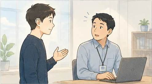 補聴器をつけた男性が、パソコンに向かう上司の席へ自分から行き、身ぶりを交えて話しかけている。上司は顔を上げて聞いている